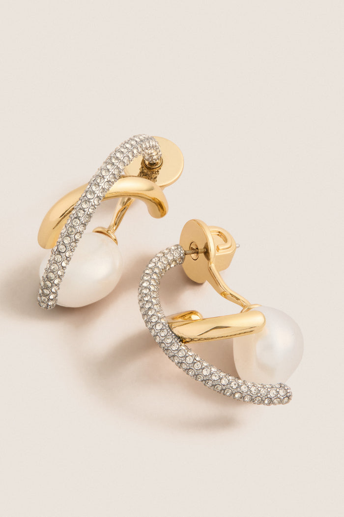 Gold Waverly Earrings: Classic gold-tone hoops adorned with pavé-set crystals, featuring an effortless dangling pearl, exuding a high-end, fun style.