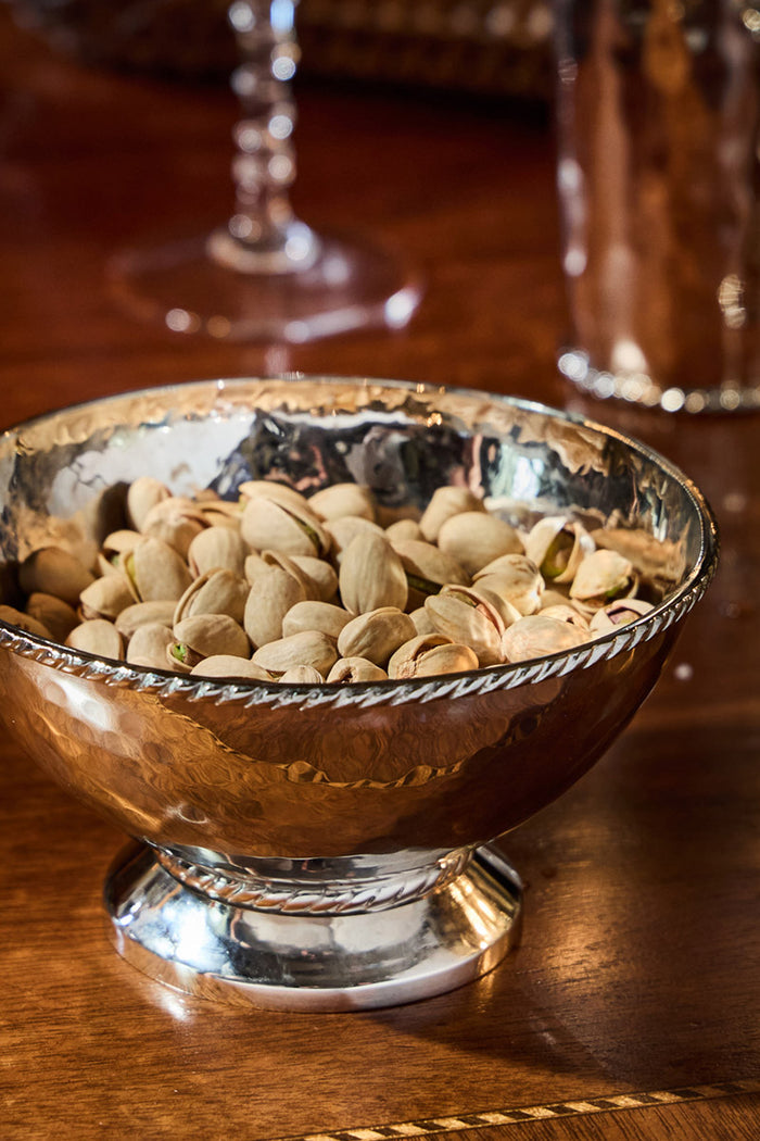Graham 6 Cocktail Bowl: A classic, high-end hammered-metal bowl filled with pistachios, embodying effortless elegance and fun, perfect for elevating any cocktail hour.