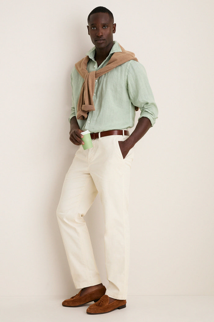 Man wearing the Grandview Shoreside Linen Sports Shirt, effortlessly styled with chinos and loafers, embodies Tuckernuck's classic and high-end fashion for a fun, confident look.