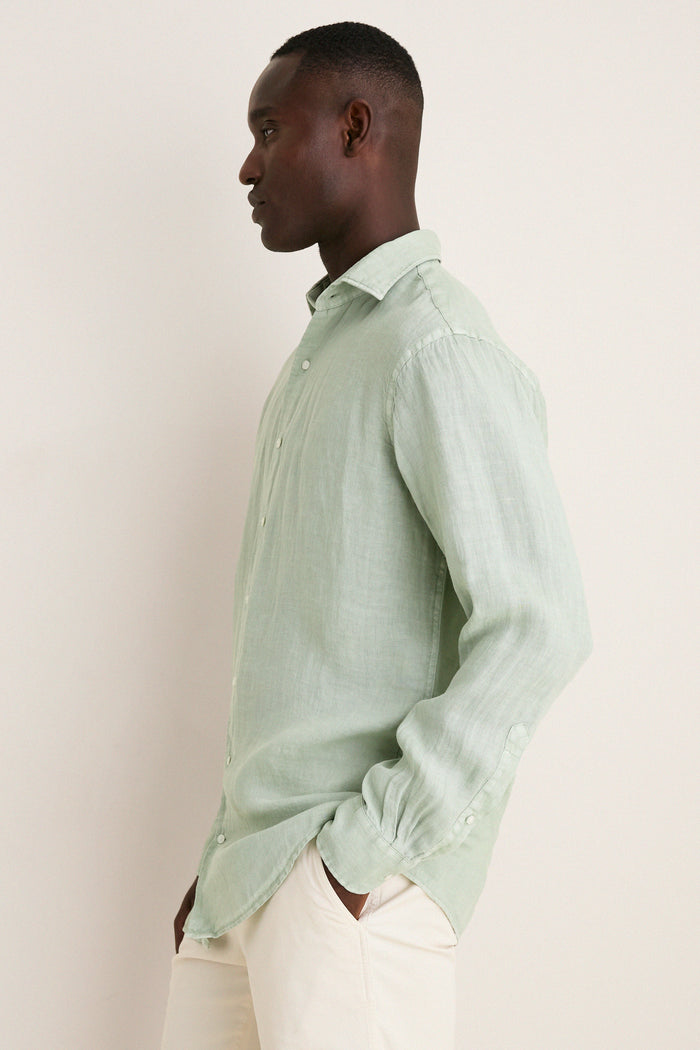 Side-profile of a man in a classic, high-end Grandview Shoreside Linen Sports Shirt, showcasing effortless style with its button-down detail and lightweight, easy-care fabric.