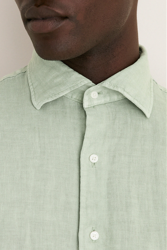 Close-up of a person wearing the Grandview Shoreside Linen Sports Shirt, a classic, effortless high-end button-down with a button-down collar, perfect for a fun, confident look.