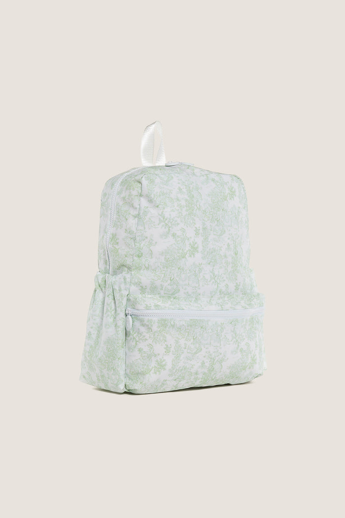 Green Bunny Toile Backpack with classic toile pattern, effortless design featuring a zippered main compartment, front zip pocket, side pockets, and a fun white carry loop.