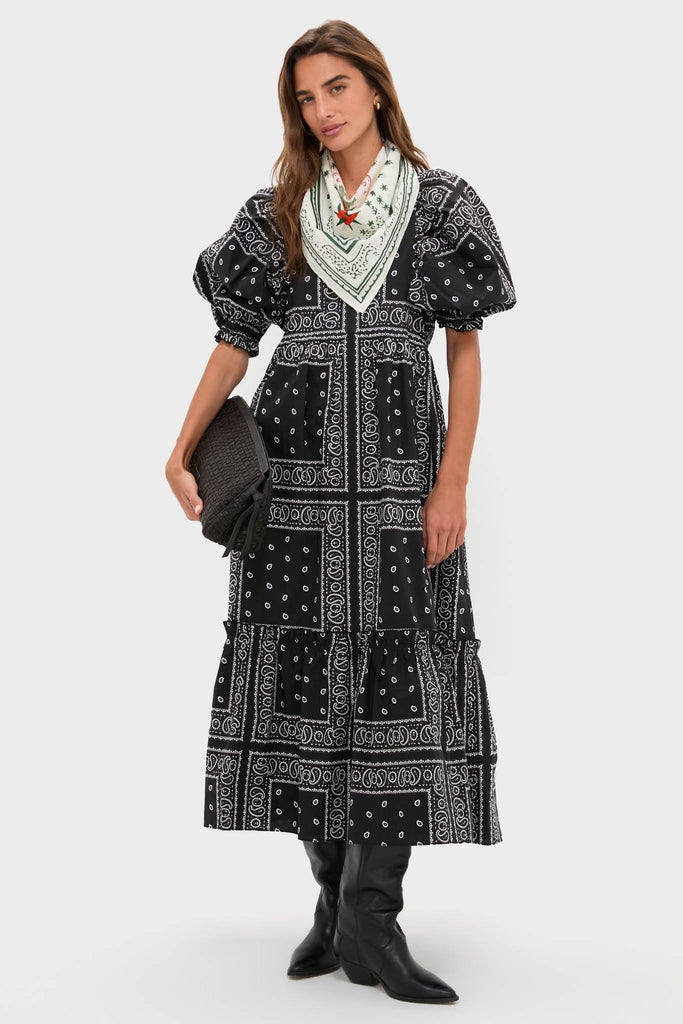 Model wearing a high-end black dress with a white bandana pattern, styled with a Hunter Bell x Tuckernuck Stars at Night Scarf, creating an effortless, classic, fun western look.