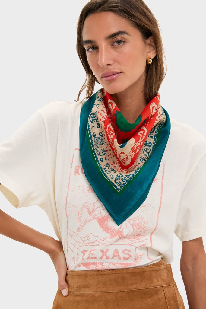 Person wearing the HB x Tuckernuck Texas Strong Scarf, a paisley-print accessory exuding classic, effortless style, adding a touch of fun and high-end flair.
