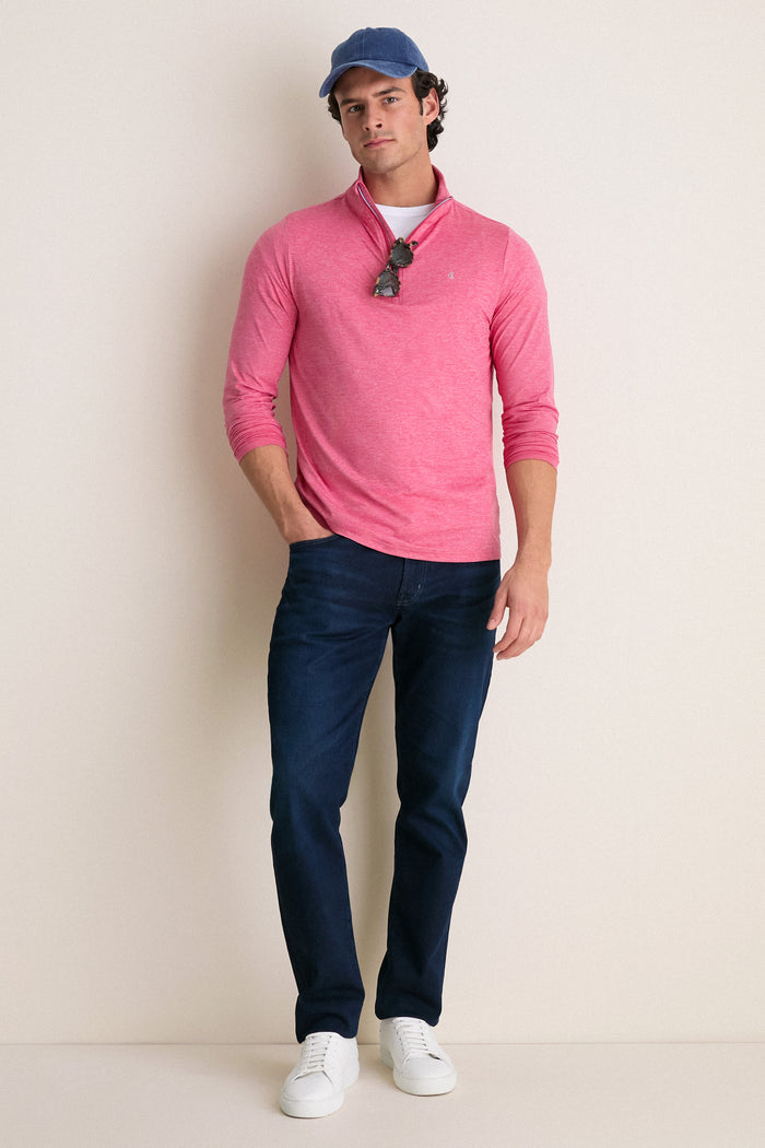 Young man models classic Heathered Red Featherweight Performance Pullover; features effortless style, stand collar, and sunglasses, embodying Tuckernuck's fun, high-end lifestyle.