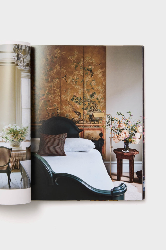 Interiors: Styled by Mieke Ten Hav showcases a classic, high-end bedroom with an effortlessly chic dark-green bed, botanical room divider, and fun floral accents.