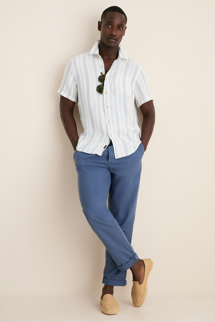 Island Blue Stripe Palma Linen Shirt effortlessly styled with mid-blue trousers and tan espadrilles, showcasing a classic, high-end summer look. Perfect for fun, warm-weather outings.