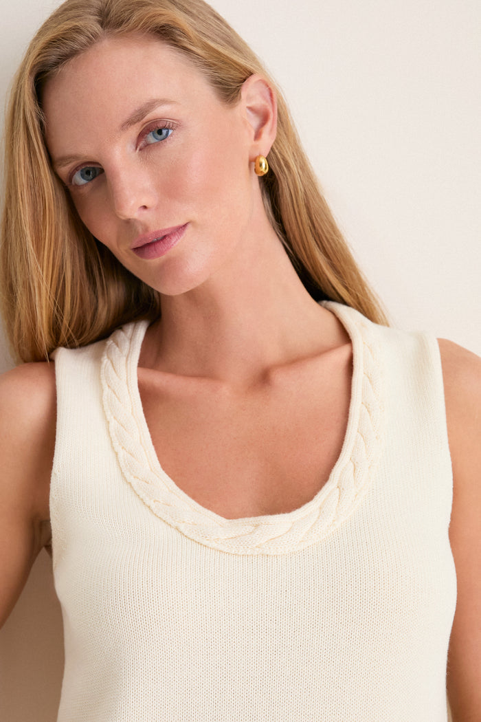 Young woman models the classic Ivory Cotton Rope Mariner Tank featuring a scalloped neckline, paired with a gold hoop earring, embodying effortless, high-end style.