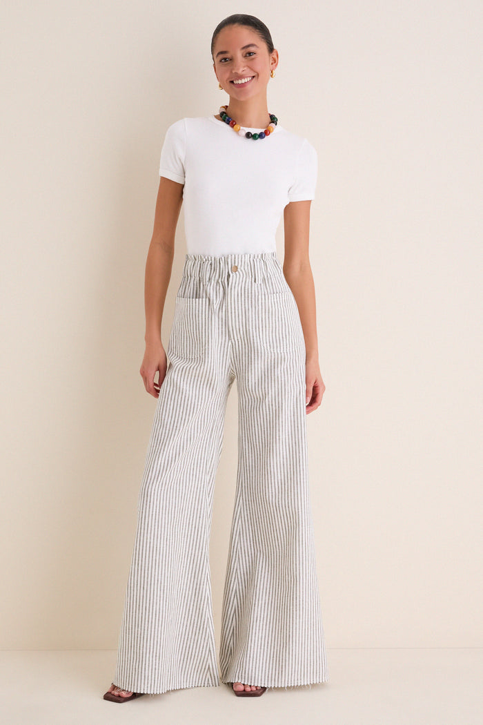 Young woman models the Juniper Stripe Linen Tulip Wide Leg Pant, showcasing its classic wide-leg, effortless fit, and fun coastal style with high-end appeal.