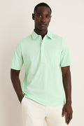 Young Black man wearing the classic Key West Oxford Pique Players Shirt, featuring a spread collar and chest flap pocket, paired effortlessly with trousers for a fun, high-end look.
