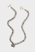 Labradorite Sidonie Necklace: A classic, high-end piece featuring faceted grey-blue labradorite beads and a smokey-grey stone in a gold-tone setting, offering effortless elegance and fun style.