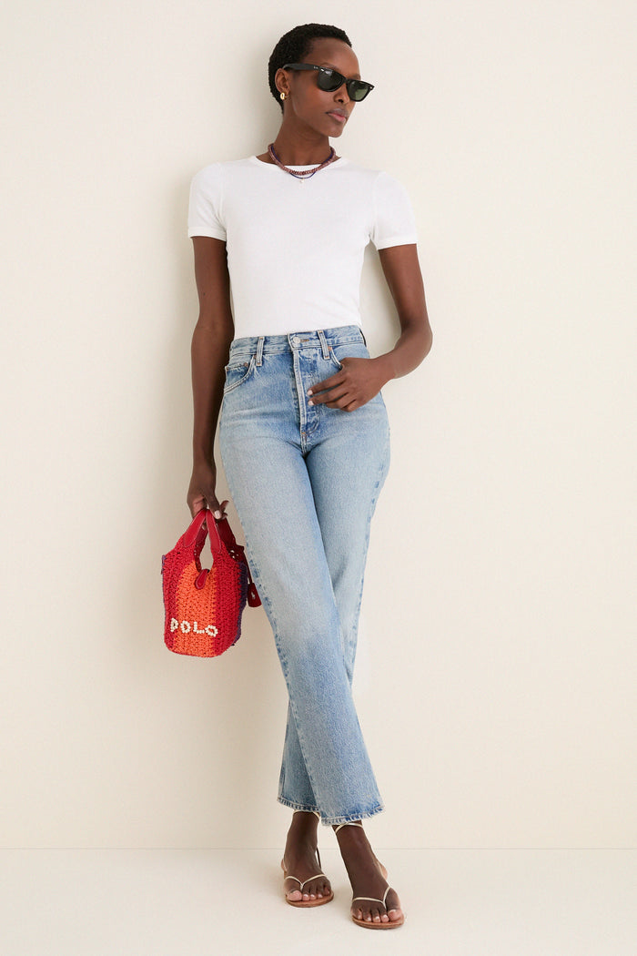 Person in a classic, effortless outfit with Lapis Lazuli Teeny Gemstone Necklace featuring a cloud pearl charm, adding fun and high-end style to their look.