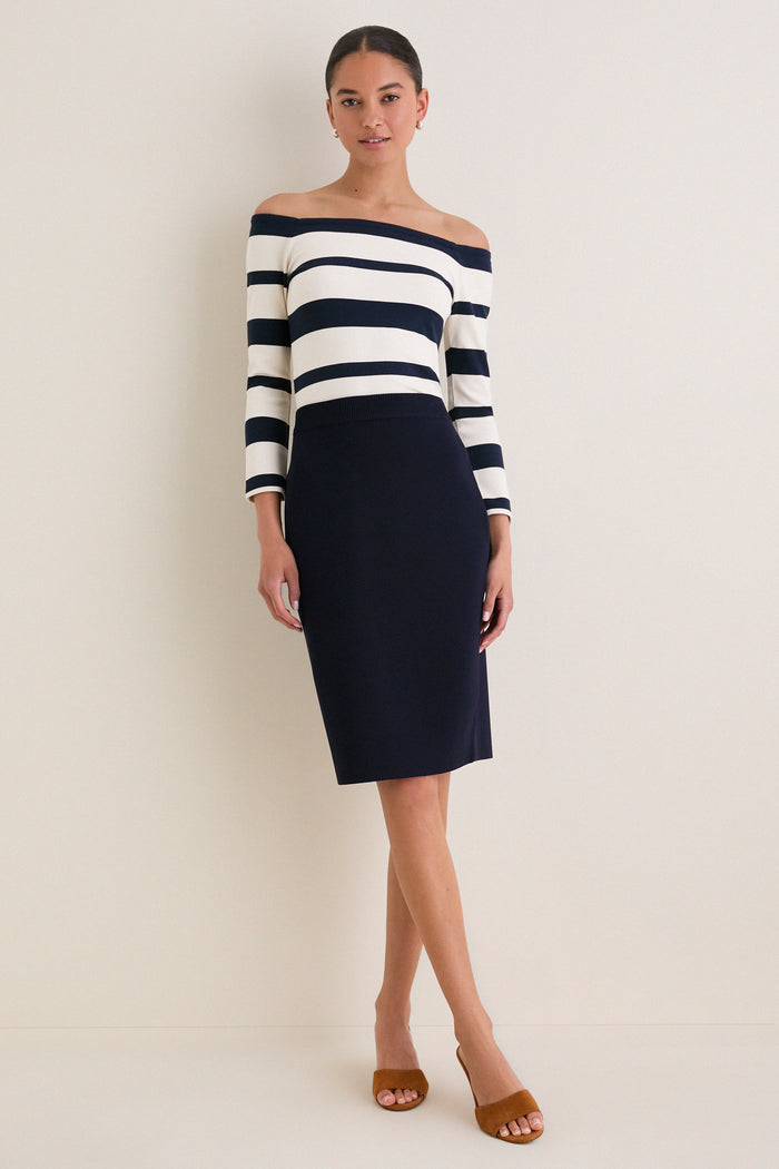 Liberty Stripe Knit Boyers Top, a classic off-the-shoulder piece with three-quarter sleeves and variegated stripes, styled effortlessly with a pencil skirt for a high-end look.