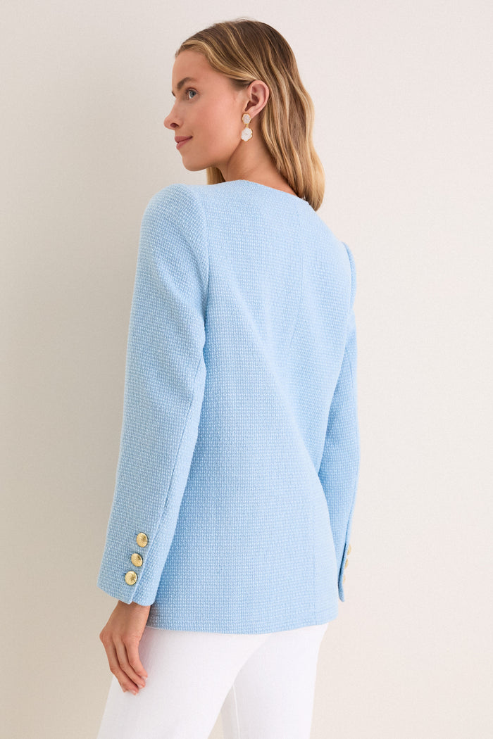Light Blue Tweed Jennings Jacket on woman, showcasing classic, high-end style with gold buttons and flap pockets. Effortlessly fun and professional ensemble with drop earrings.