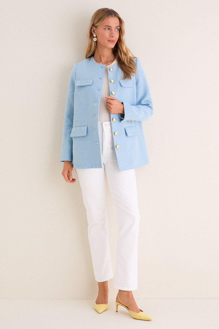 Model wearing a classic Light Blue Tweed Jennings Jacket with gold buttons, styled effortlessly over a white top and jeans, paired with fun yellow heels.