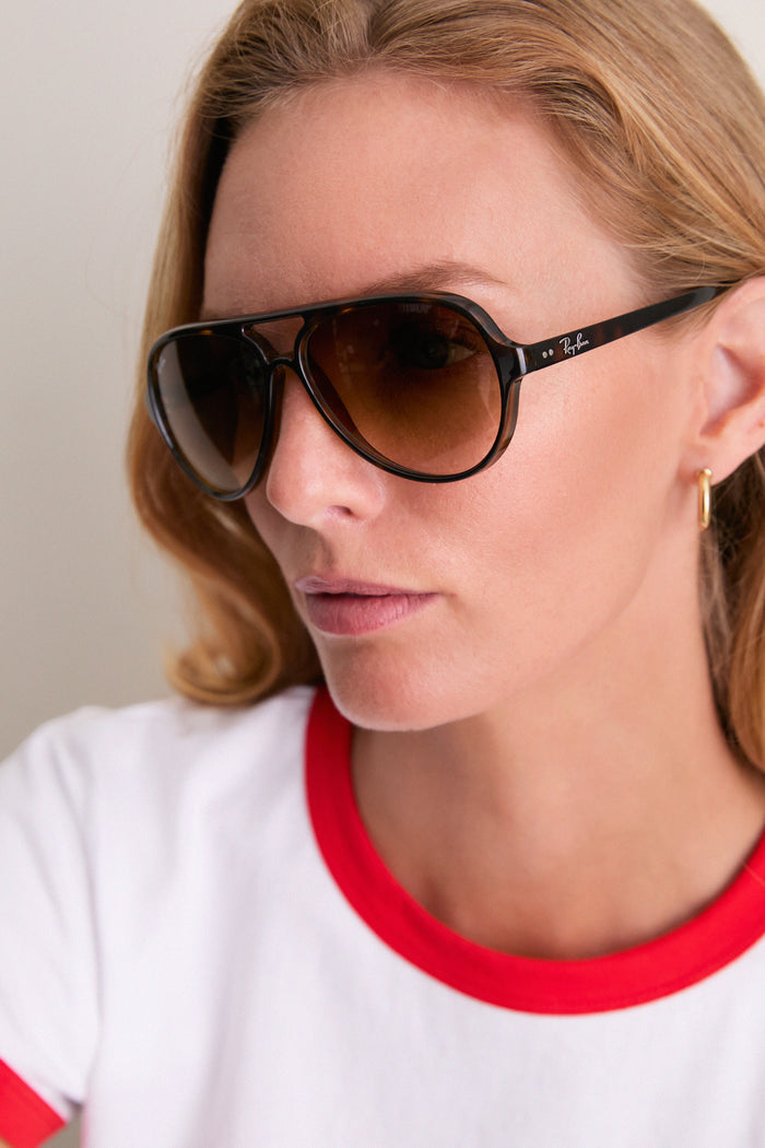 Light Havana Cats 5000 Classic Sunglasses on woman, showcasing aviator style with tortoiseshell frames and brown-tinted lenses; a high-end, effortless, and classic look with fun appeal.