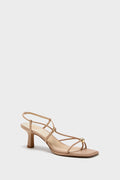 Light Tan Mylee Heels: Classic, effortless dress sandal with a flared block heel, crisscross straps, and gold-tone accents, exuding high-end, fun style.