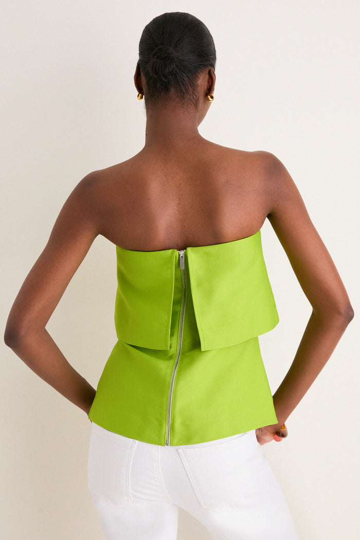 Model wears the Lime Felix Satin Strapless Top, showcasing its classic, effortless design with a sleek zipper and chic fold-over neckline.