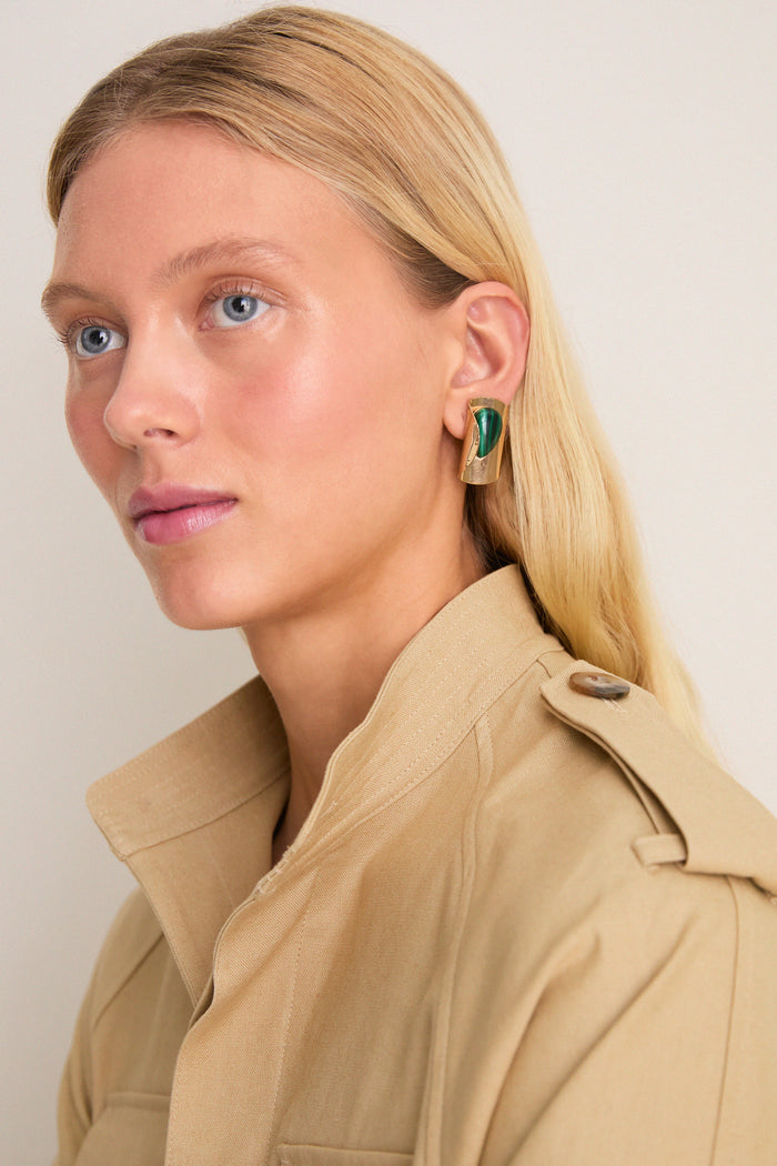 Close-up of Malachite Keziah Earrings on a woman, showcasing classic, sculptural gold design with green stone, blending effortless elegance with a fun, high-end artisan touch.
