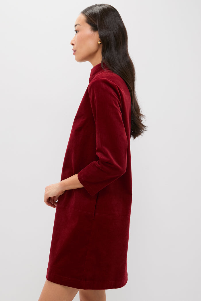 Merlot Corduroy Clifton Dress: A classic, high-end style with a stand collar, V-neckline, and three-quarter sleeves, offering an effortless, fun look for versatile occasions.