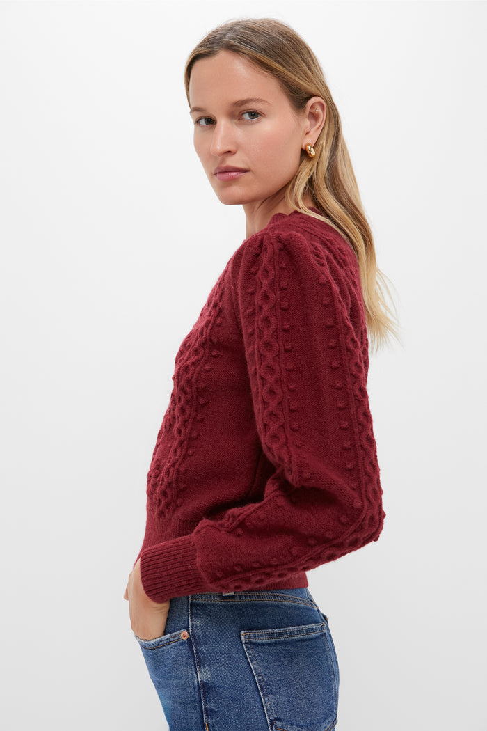 Woman in side-profile wearing a classic, high-end Merlot Embroidered Floral Frankie Sweater with textured knit, paired with jeans, exuding an effortless, fun style.
