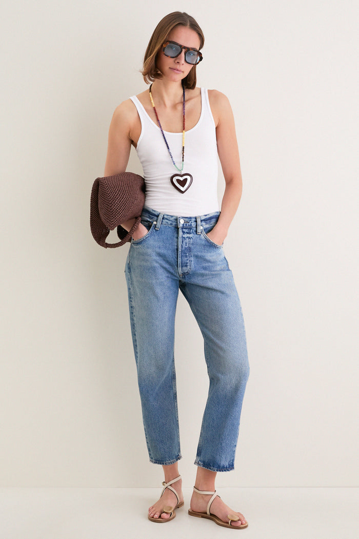 Young woman wearing the Multi Alma Necklace, a classic, high-end piece with a heart pendant, showcasing effortless style and fun sophistication, perfect for everyday or weekend outings.