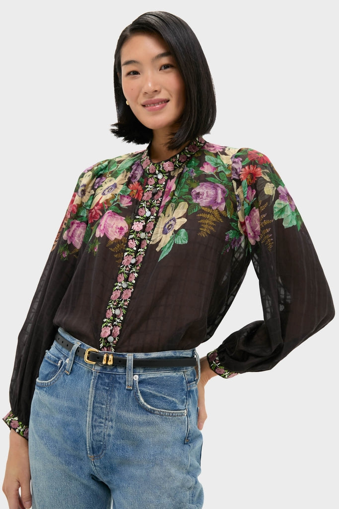 Person wearing the classic Multi Viktoria Print Long Sleeve Blouse with bold floral design, tucked into high-rise jeans. An effortless, fun, high-end look.