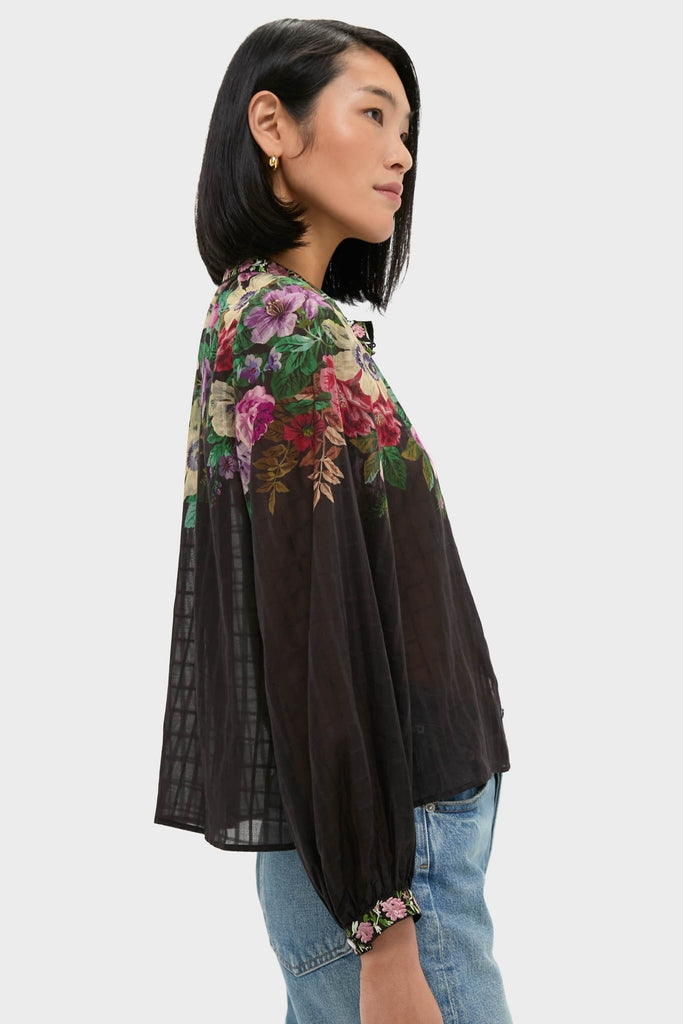 Woman in profile wearing the classic Multi Viktoria Print Long Sleeve Blouse with voluminous sleeves, paired effortlessly with jeans, showcasing a fun, high-end feminine look.