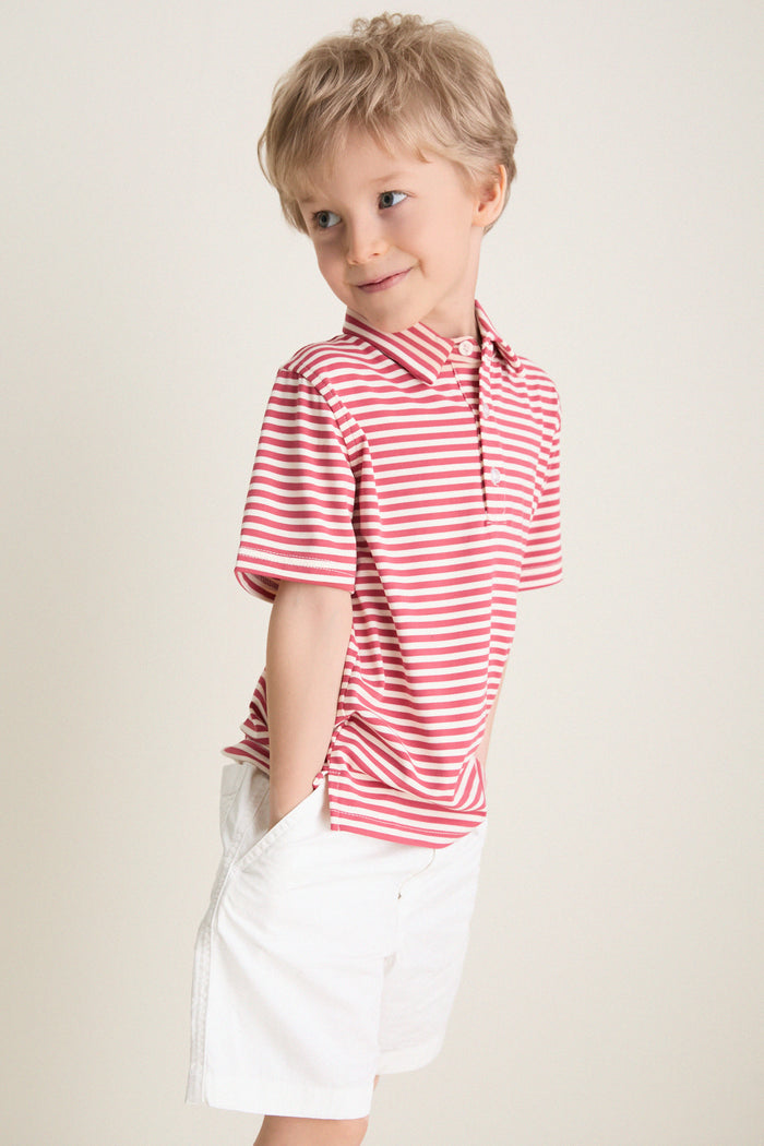 Preschool child in a classic, effortless Nantucket Red and Creme Le Club Polo, hands in pockets, embodying fun and high-end style with discrete back embroidery.