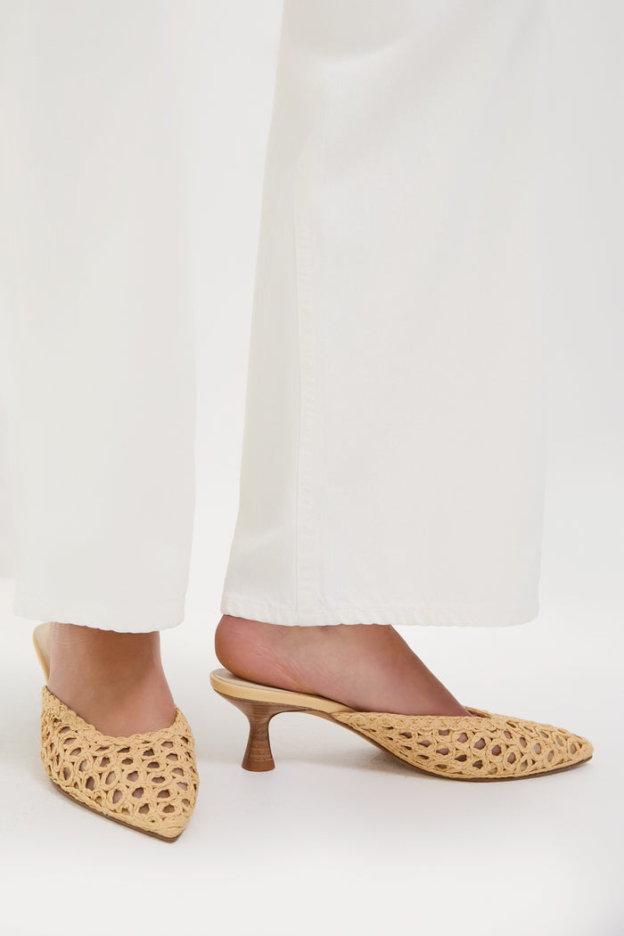 Effortlessly chic, the Natural Cleo Loop Heels feature a classic open-weave design with a high-end turned-wood kitten heel, embodying Tuckernuck’s fun and confident style.