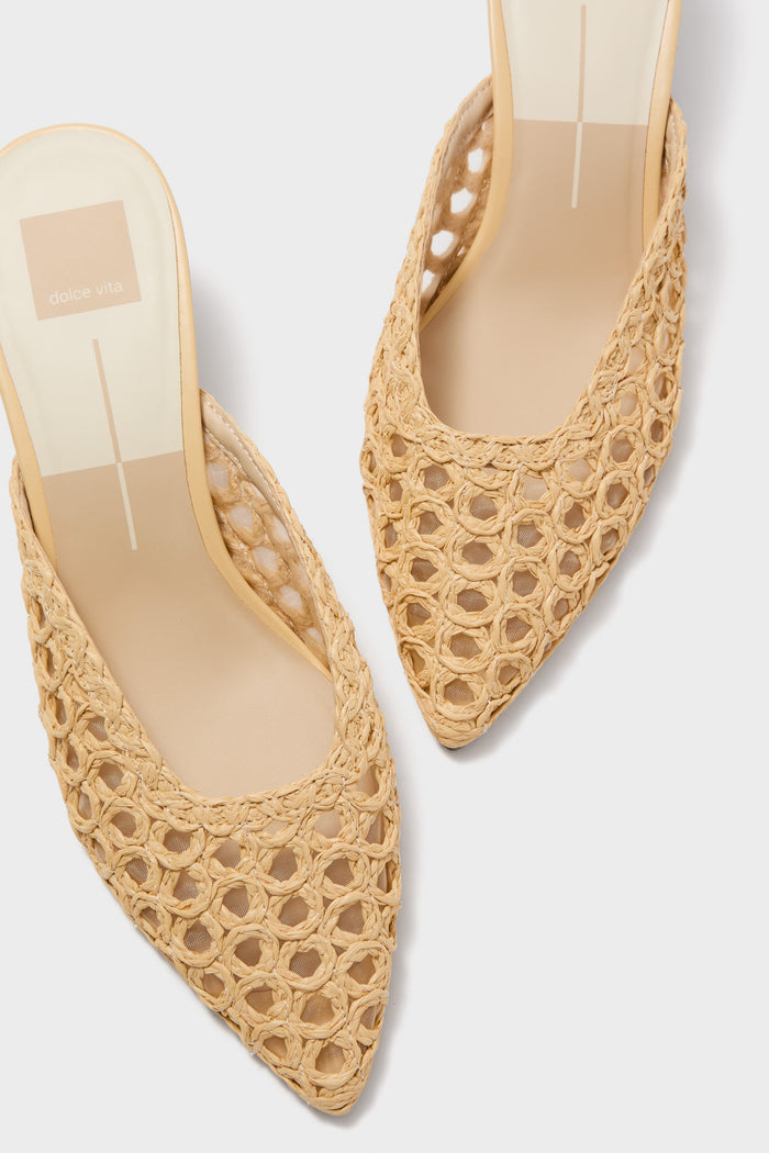 Natural Cleo Loop Heels: Classic and effortless mules with a woven raffia-style upper and pointed toes, embodying high-end, fun sophistication.