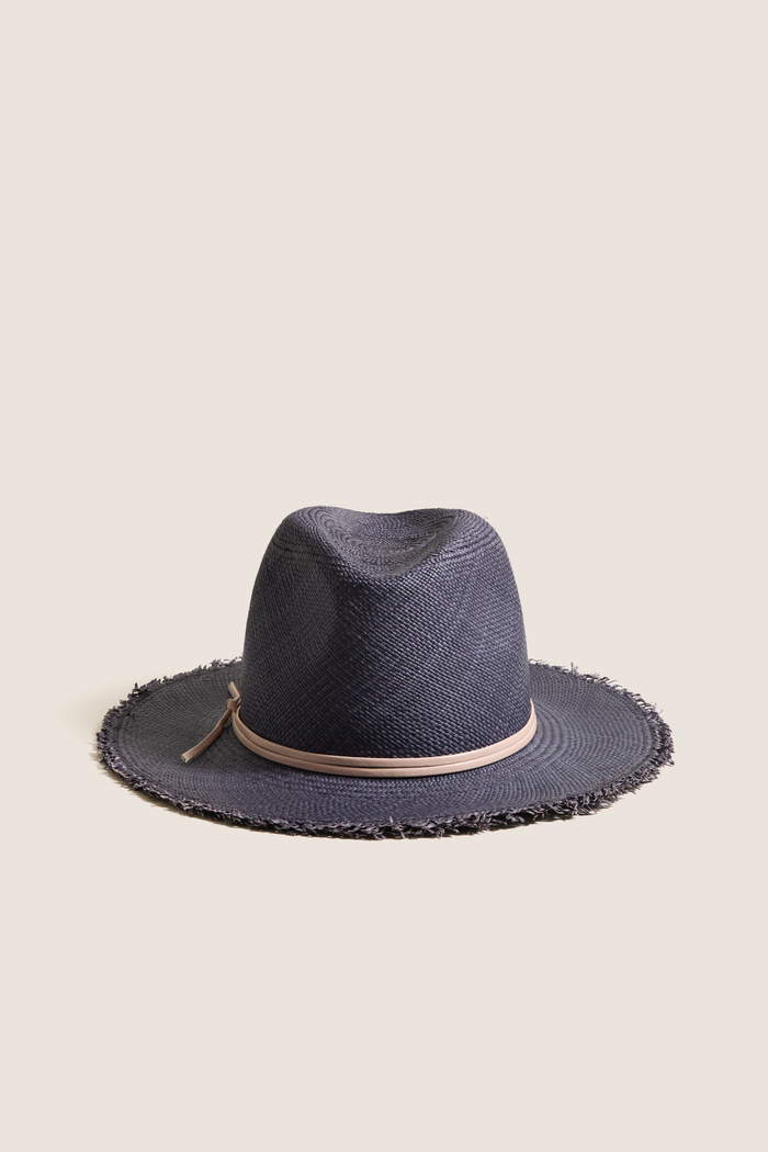Navy and Tan Fringed Pammy Panama Continental Hat, a classic and effortless woven straw design with a playful fringe brim and tan leather band, perfect for fun, high-end sun-ready adventures.