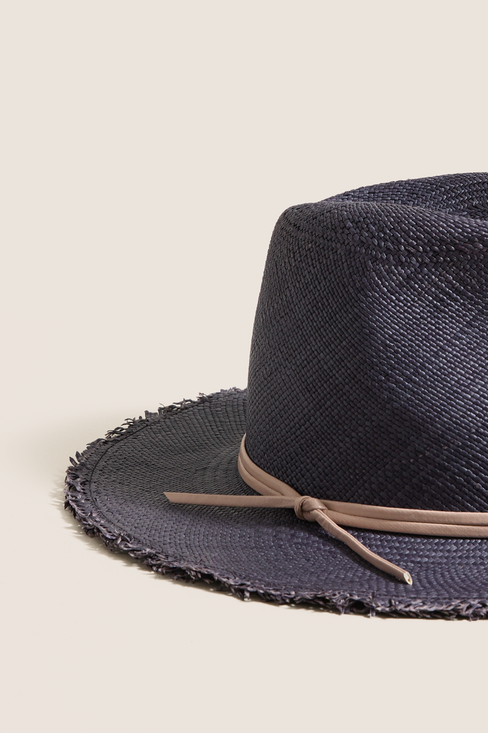 Navy and Tan Fringed Pammy Panama Continental Hat: A classic, effortless straw hat with a fun fringe brim and high-end leather band, perfect for sun-filled adventures.