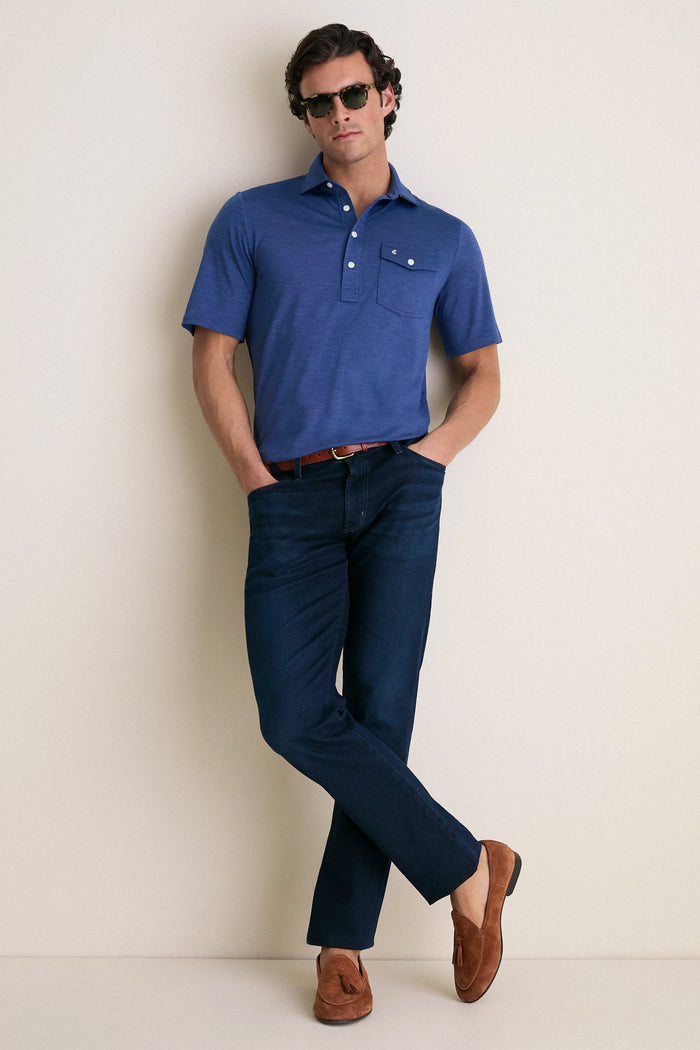 Casually dressed man in a classic, medium-blue Navy Captain Heather Performance Sport Players Shirt with a relaxed fit, embodying effortless style and high-end comfort.