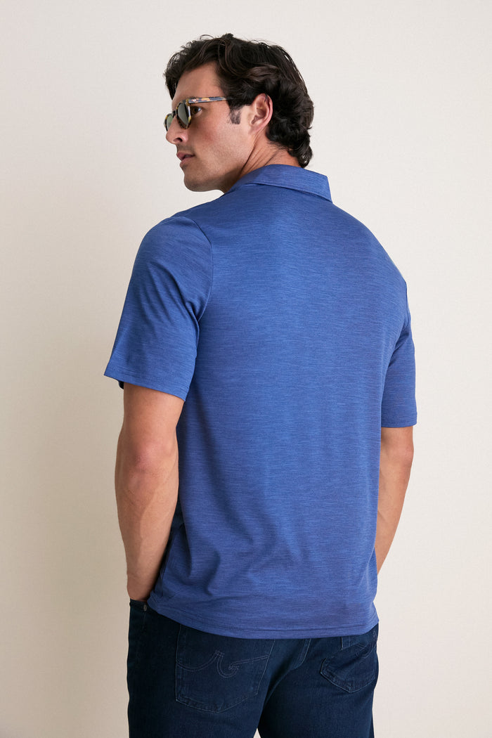 Man in profile wearing a classic, high-end Navy Captain Heather Performance Sport Players Shirt, showcasing effortless style with its 4-button placket and short sleeves.