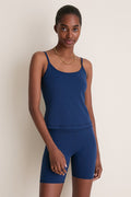 Young woman in a classic, high-end Navy Compression Spandex Sofia Cami with adjustable straps, built-in shelf bra, and compression fabric, embodying an effortless, fun style.