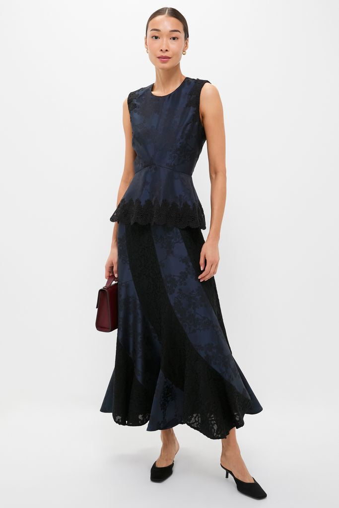 Model wearing the classic Navy and Black Lace Margy Top with scalloped lace peplum, paired with a matching skirt, exuding an effortless, high-end, and fun style.