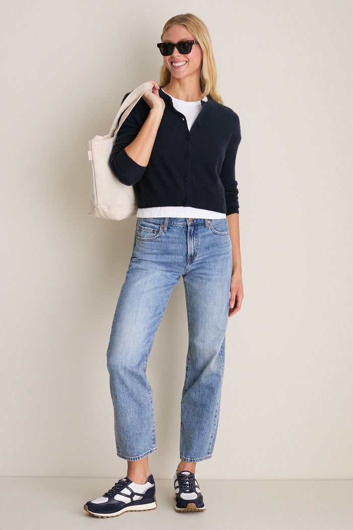 Young woman in classic, effortless style wearing Navy Multi Valentina Sneakers. The sneakers feature a chic, two-tone design with suede detailing, embodying high-end comfort and fun.