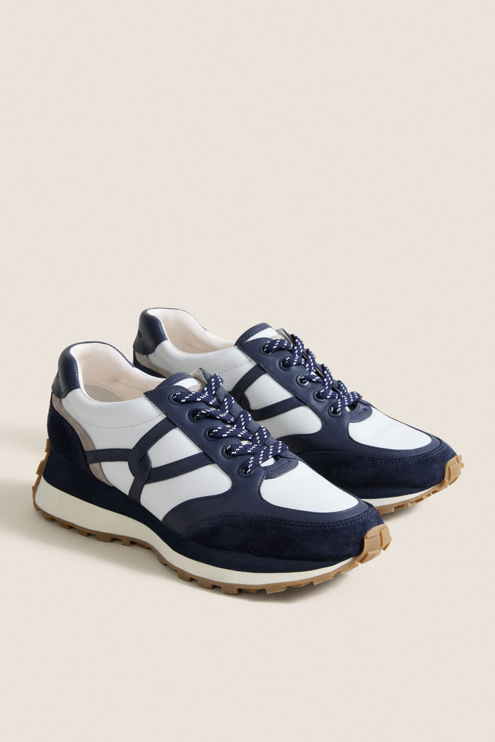 Navy Multi Valentina Sneakers: Classic low-top sneakers with white leather, navy suede overlays, and speckled laces. Effortlessly chic, fun, and high-end for everyday wear.