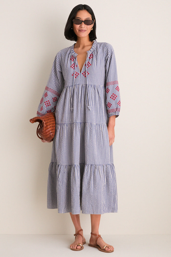 Woman wearing the Navy Prism Embroidered Gingham Long Sleeve Salty Paloma Caftan, showcasing a classic, effortless style with fun, high-end details.