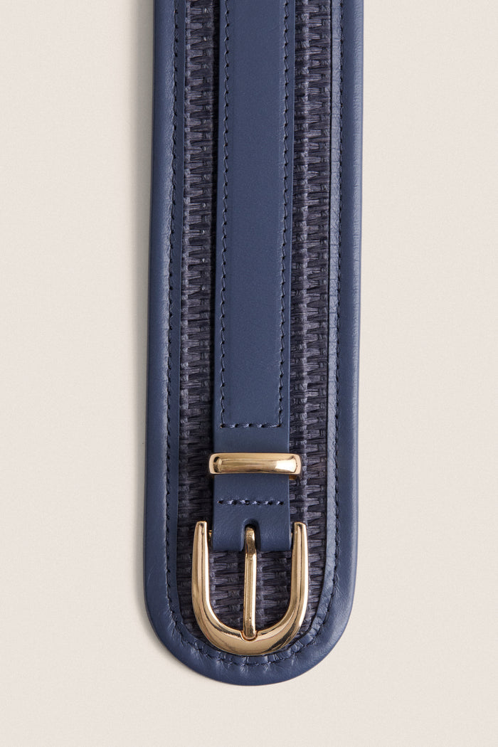 Navy Raffia Waist Belt with classic woven detailing, leather trim, and high-end gold-tone buckle, effortlessly cinches waists for a fun, flattering look.