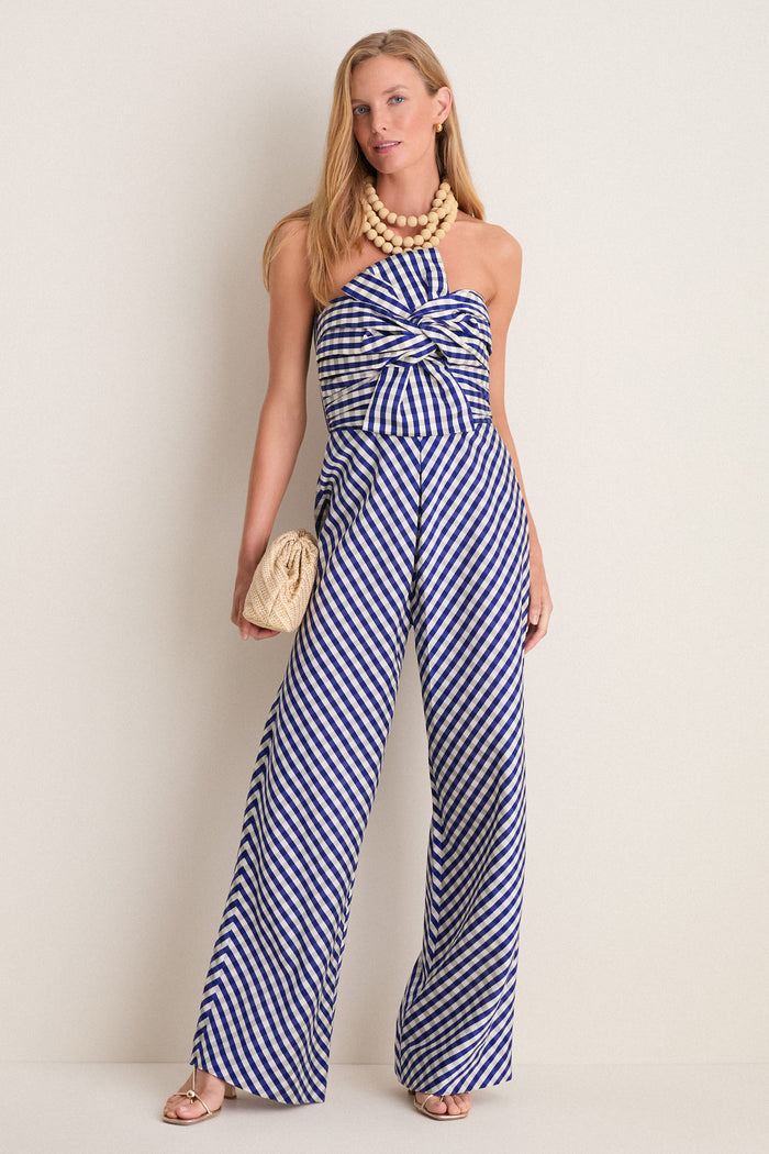 Ocean Gingham Kat Jumpsuit on model; effortless, classic style with sweetheart neckline, oversized bow, high-waisted trousers, and multi-strand necklace for a fun, high-end look.