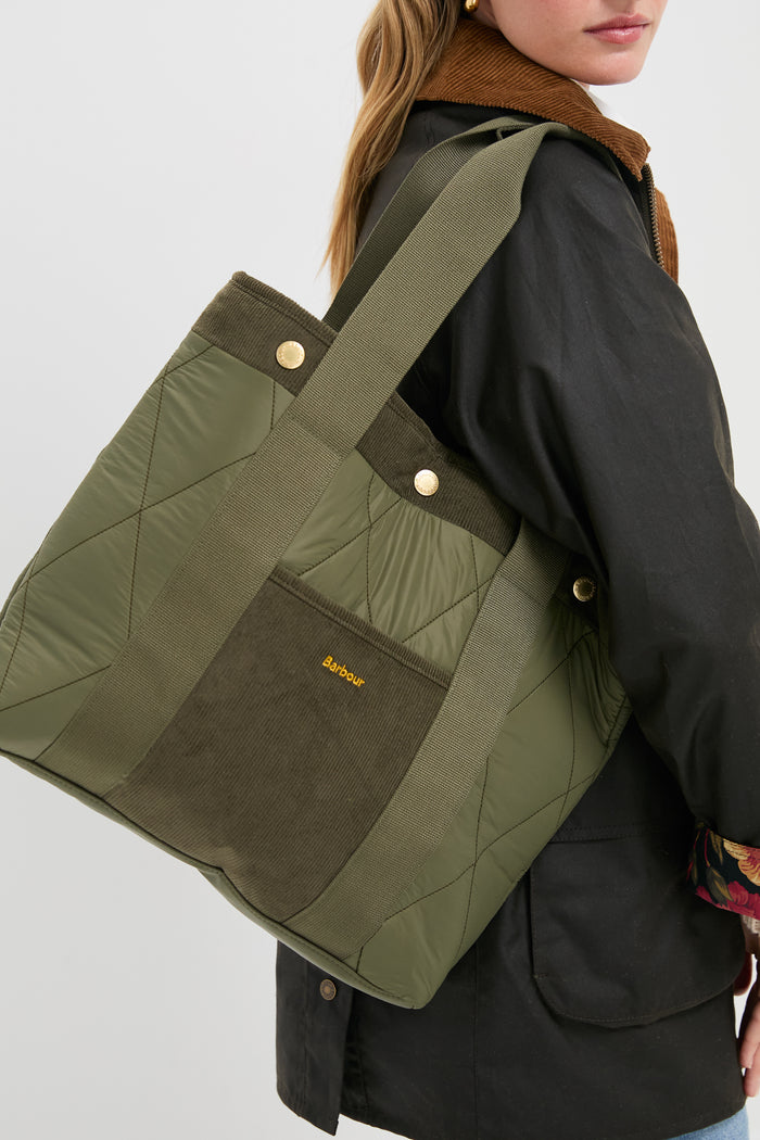 Olive Healy Tote Bag with classic diamond quilting, corduroy accents, and gold details, effortlessly combining high-end style and fun practicality.