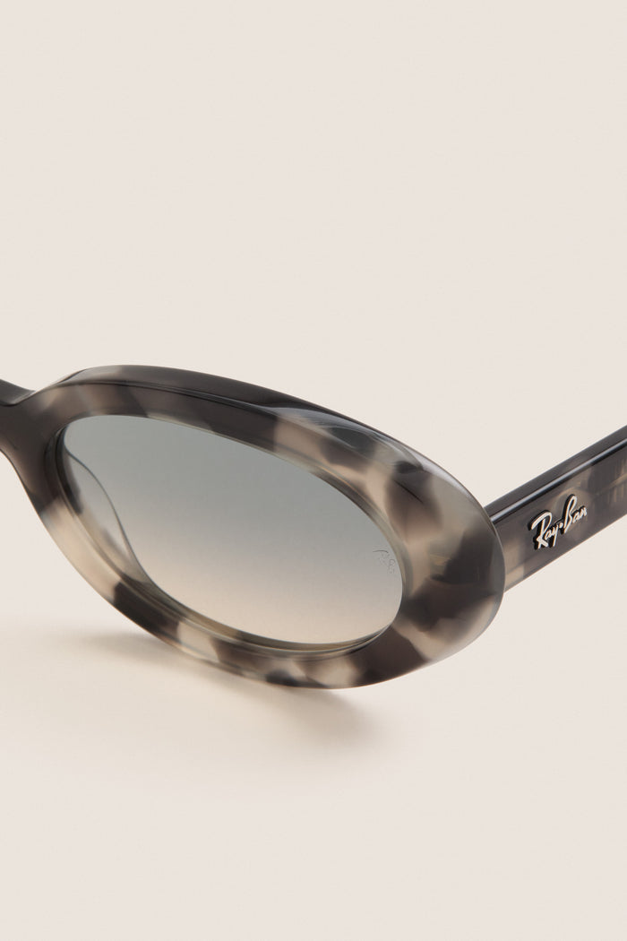 Opal Grey Havana RB2223 Sunglasses feature a classic tortoiseshell oval frame, gradient lenses, and a silver Ray-Ban logo, offering an effortless, high-end, fun style.