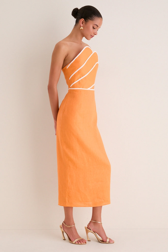 Orange Linen Clementine Maxi Dress features a classic strapless design with contrast piping, a smocked back, and a vented hem. Effortlessly fun and high-end with gold accessories.
