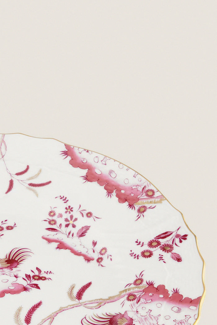 Oro Di Doccia Magenta Dinner Plate features a classic porcelain design with an effortless pink floral pattern, fun gold-trimmed edge, embodying high-end Italian craftsmanship.