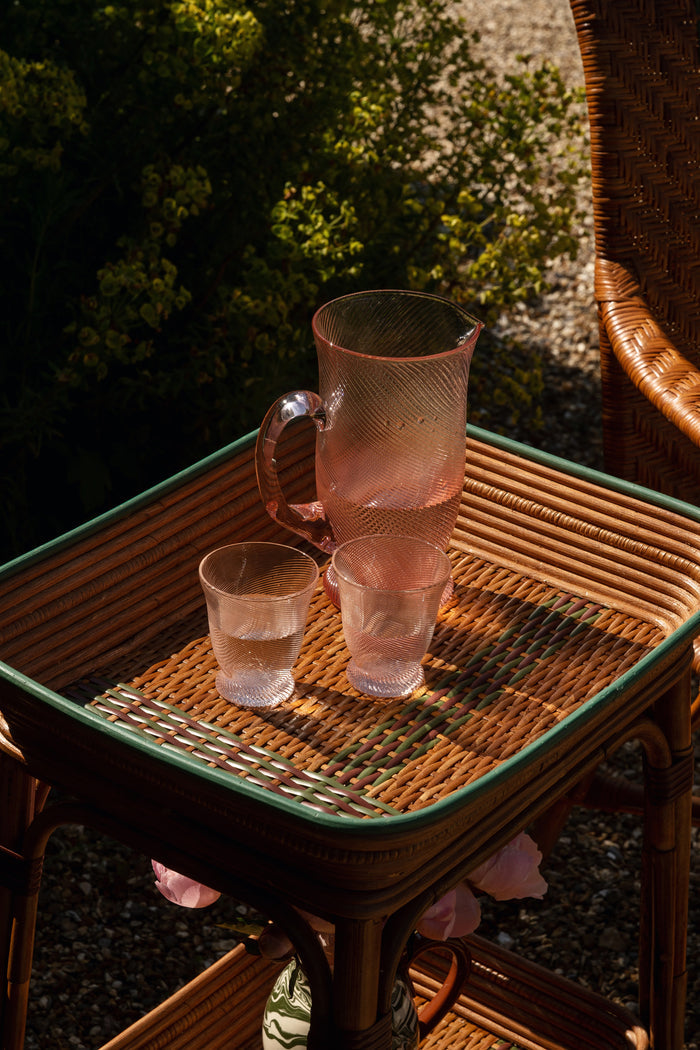 Peony Pink Spiral Tumbler on a woven-rattan table, embodying classic elegance. Perfect for effortless, fun gatherings, adding a high-end touch to any setting.