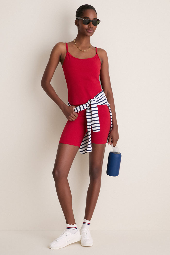 Red Compression Spandex Sofia Cami on a slim woman, showcasing a classic, effortless fit with adjustable straps and built-in bra, perfect for a fun, high-end style.