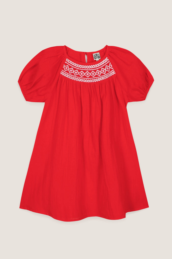 Red Nala Dress: A classic, effortless girls' dress with puff sleeves and geometric embroidery, perfect for high-end, fun style on warm days.