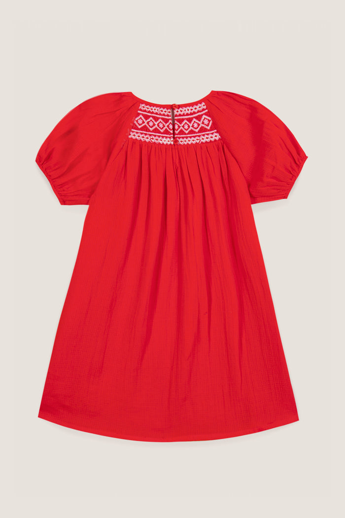 Red Nala Dress: A classic knee-length red dress with short puff sleeves, featuring effortless white geometric embroidery on the yoke and a fun gathered skirt. Perfect for high-end, chic styling.